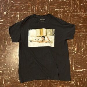 A Scarface shirt of him in the bathtub